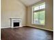 Bright living room with a fireplace and beautiful hardwood floors at 14211 Harlequin Dr, Charlotte, NC 28273