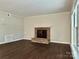 Living room featuring a brick fireplace and hard wood floors at 14211 Harlequin Dr, Charlotte, NC 28273