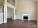 Bright living room with a fireplace and beautiful hardwood floors at 14211 Harlequin Dr, Charlotte, NC 28273