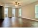 Open main bedroom featuring a ceiling fan and windows at 14211 Harlequin Dr, Charlotte, NC 28273
