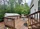 Outdoor wooden deck showcasing a table with a glass top and black and white rug at 146 Larboard Trl, Mount Gilead, NC 27306