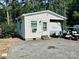 Quaint one-story home with white siding, complemented by an adjacent RV and golf cart at 146 Larboard Trl, Mount Gilead, NC 27306