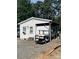 One-story home with an RV parked under a covered area, providing convenient outdoor living space at 146 Larboard Trl, Mount Gilead, NC 27306