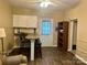 Inviting living room featuring a cozy couch, a kitchenette, and wood-look floors at 146 Larboard Trl, Mount Gilead, NC 27306