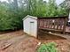 White shed on a lush green lot with stairs leading down to the backyard at 146 Larboard Trl, Mount Gilead, NC 27306