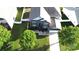 Aerial shot showcasing a well-maintained two-story home with lush greenery and a white picket fence at 14615 Bridle Trace Ln, Pineville, NC 28134