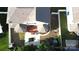 An expansive backyard featuring a patio, garden, and recreational area, all enclosed by a pristine white fence at 14615 Bridle Trace Ln, Pineville, NC 28134