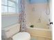 Bathroom featuring a shower, tub, window, and floral shower curtain at 14615 Bridle Trace Ln, Pineville, NC 28134