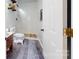 Well lit bathroom featuring a wood shower floor, vanity, and stylish rug at 14615 Bridle Trace Ln, Pineville, NC 28134
