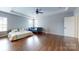Bright bedroom with hardwood floors, ceiling fan, and ample natural light at 14615 Bridle Trace Ln, Pineville, NC 28134