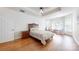 Cozy bedroom featuring hardwood flooring, a ceiling fan, and natural lighting at 14615 Bridle Trace Ln, Pineville, NC 28134