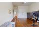 Bedroom featuring hardwood floors, animal wall decor, and a modern desk at 14615 Bridle Trace Ln, Pineville, NC 28134