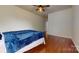 Bedroom boasts wood floors, a ceiling fan, and a doorway visible on the right side at 14615 Bridle Trace Ln, Pineville, NC 28134