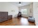 Bedroom featuring hardwood floors, wall decor, and a modern desk at 14615 Bridle Trace Ln, Pineville, NC 28134