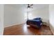 Bright bedroom featuring hardwood floors, a ceiling fan, and natural light from the windows at 14615 Bridle Trace Ln, Pineville, NC 28134