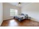 Bedroom featuring hardwood floors, neutral walls, and a ceiling fan at 14615 Bridle Trace Ln, Pineville, NC 28134
