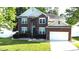 Charming two-story brick home with manicured lawn and attached two-car garage, located on a tree-lined street at 14615 Bridle Trace Ln, Pineville, NC 28134