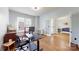 Bright office space with hardwood flooring and an open doorway to the living room at 14615 Bridle Trace Ln, Pineville, NC 28134