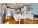 Open kitchen with white cabinets, a center island, and stainless steel appliances at 14615 Bridle Trace Ln, Pineville, NC 28134