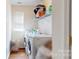 Functional laundry room featuring a washer, dryer, and shelving for storage, plus a window at 14615 Bridle Trace Ln, Pineville, NC 28134
