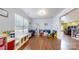 Spacious playroom with hardwood floors, offering a vibrant and engaging area for activities at 14615 Bridle Trace Ln, Pineville, NC 28134
