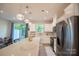 Stylish kitchen with white cabinets, stainless steel appliances, and island seating at 14806 Tamarack Dr, Charlotte, NC 28278