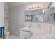 Well-lit bathroom features a vanity, mirror, and toilet at 150 8Th Ave, New London, NC 28127