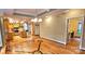 Dining room with hardwood floors, wood cabinets, and an archway leading to the kitchen at 150 8Th Ave, New London, NC 28127