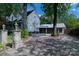 View of the home with a brick driveway leading to a two-car garage at 150 8Th Ave, New London, NC 28127
