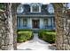 Close up of beautiful home's front exterior with a stone archway, porch, and landscaped front yard at 150 8Th Ave, New London, NC 28127