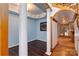 Hallway featuring hardwood floors, decorative columns, and view into other rooms at 150 8Th Ave, New London, NC 28127