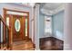 Entryway with hardwood floors, wood door with stained glass, and blue painted walls at 150 8Th Ave, New London, NC 28127