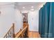 Bright hallway featuring hardwood floors, stylish railings, and an open doorway for a seamless flow at 150 8Th Ave, New London, NC 28127