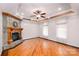 Bright living room features stone fireplace, hardwood floors and detailed trey ceiling at 150 8Th Ave, New London, NC 28127