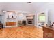 Spacious living room with a fireplace, built-in shelving, and an open doorway leading to an adjacent room at 150 8Th Ave, New London, NC 28127