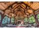 Outdoor pavilion with stone fireplace, vaulted ceiling, and rustic wood features at 150 8Th Ave, New London, NC 28127