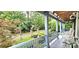 View from the porch of a landscaped front yard, stone archway, and a winding driveway at 150 8Th Ave, New London, NC 28127