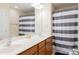 Bright bathroom with double sink vanity and a shower featuring a stylish striped curtain at 1518 Glenbar Ct, Clover, SC 29710