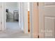 Hallway with open doors, neutral walls, and modern carpet at 1518 Glenbar Ct, Clover, SC 29710