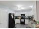 Traditional kitchen boasts white cabinets, black appliances, and modern finishes at 1518 Glenbar Ct, Clover, SC 29710
