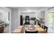 Eat-in kitchen with white cabinetry and modern black appliances and a view into the Gathering room at 1518 Glenbar Ct, Clover, SC 29710