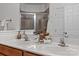 Bathroom with double sink vanity, large mirror, and a glass enclosed shower with brown tile at 1530 S Church St # K, Charlotte, NC 28203
