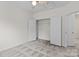 Bedroom with neutral walls, plush carpet, closet, ceiling fan, and white trim at 1530 S Church St # K, Charlotte, NC 28203