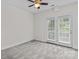 Bedroom featuring neutral walls, plush carpet, French doors, and a ceiling fan at 1530 S Church St # K, Charlotte, NC 28203