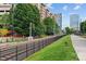 Exterior view with railroad tracks and walking path lined with a black fence at 1530 S Church St # K, Charlotte, NC 28203