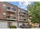 Townhouse exterior featuring brick, balconies, attached garage, and well-maintained landscaping at 1530 S Church St # K, Charlotte, NC 28203