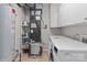 A spacious laundry room with washer, dryer, water heater, and shelving units at 1530 S Church St # K, Charlotte, NC 28203