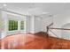 Sunlit living room featuring hardwood floors, bay windows, and a staircase at 1530 S Church St # K, Charlotte, NC 28203