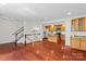 Open concept living space features hardwood floors, white stair rails, and a modern island kitchen at 1530 S Church St # K, Charlotte, NC 28203