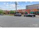 Street view of a multi-tenant commercial building with storefronts and street parking at 1530 S Church St # K, Charlotte, NC 28203